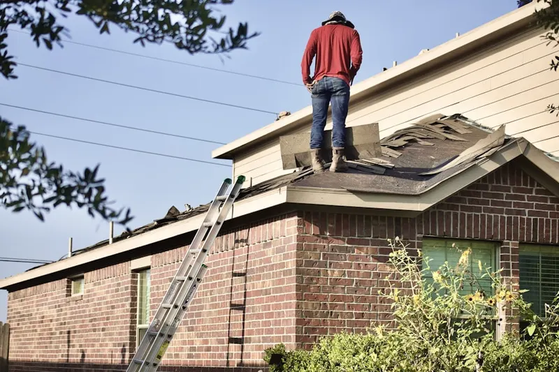 Professional roofer working on a residential roof in Sky View